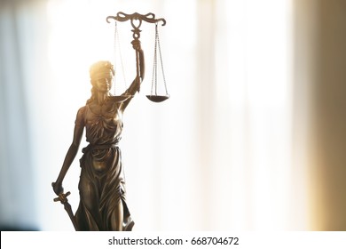 Statue of Justice with scales in lawyer office. Legal law, advice and justice concept - Shutterstock ID 668704672