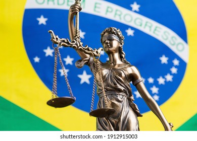 The statue of justice Themis or Justitia, the blindfolded goddess of justice against the flag of Brazil, as a legal concept