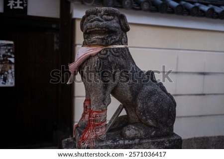 statue of a komainu, one of the most ubiquitous and recognizable symbols of sacred sites in Japan. It stands guard at the entrances of countless Shinto shrines and Buddhist temples.