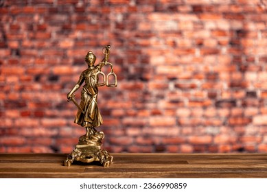 statue of Lady Justice, goddess Justitia, on the desk in a lawyer's office on books