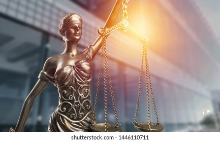 Statue of the lady of justice with scales close-up on the background of the judicial building