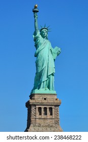 Statue Of Liberty With Its Base On A Blue Background In New York City