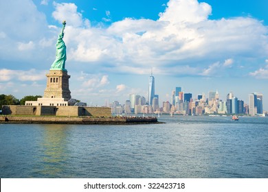 The Statue of Liberty with the downtown Manhattan skyline on a beautiful summer day