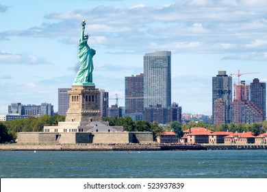 The Statue Of Liberty In New York City With Skyscrapers On The Background