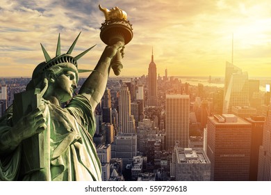 The Statue of Liberty and New York City skyline at dark - Shutterstock ID 559729618