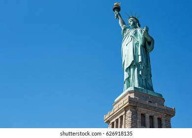 Statue of Liberty on clear blue sky in a sunny day, low angle view with clipping path - Powered by Shutterstock