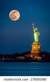 Statue Of Liberty And A Rising Supermoon In New York City