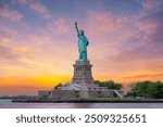 Statue of Liberty at sunset and Manhattan skyline, New York City