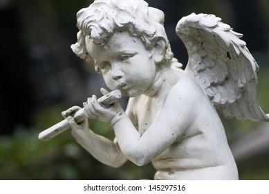 Statue Of A Little Angel On Cementery.