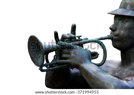 the statue of man sitting and blowing trumpets.