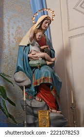 Statue Of Mary With The Baby Jesus In A Sicilian Village Church