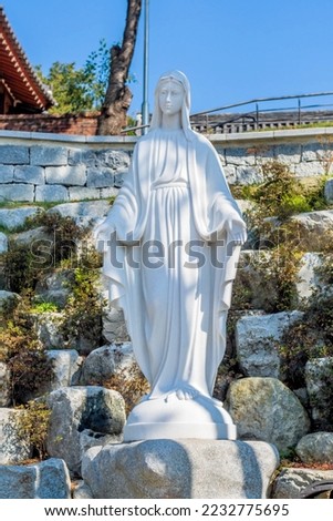 Statue of Mother Mary in rock garden at Nabawi Catholic Church in Iksan, South Korea.