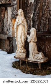 Statue of a Nun Praying in Front of a White Madonna Statue - Shutterstock ID 2258251033