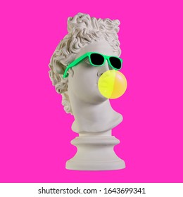 Statue on a pink background. Gypsum statue of Apollo head. Man. Creative. Plaster statue of Apollo head in sunglasses. Minimal concept art.