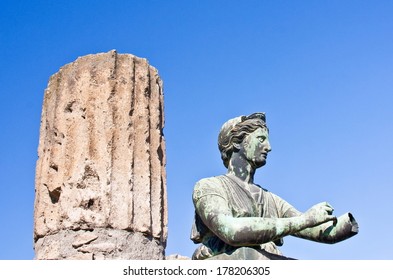 Statue On Top Of Diana With A Column At Pompeii On A Blue Day