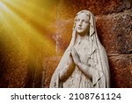 Statue of Our lady of grace virgin Mary view with natural background in the rock cave at Thailand. selective focus.