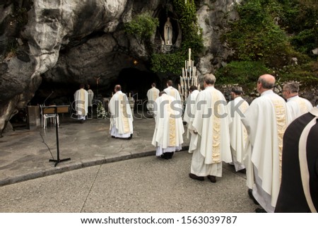 Statue of Our Lady of Immaculate Conception with a rosary in the Grotto of Massabielle in Lourdes, France - preparation for the Eucharist