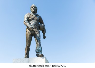 Statue Of The Polish Coach Kazimierz Gorski With A Ball Walking In His Tracksuit Outside The National Stadium On The Blue Sky Commemorating Seventies Of The Football Glory. Warsaw Poland 2018/4/30