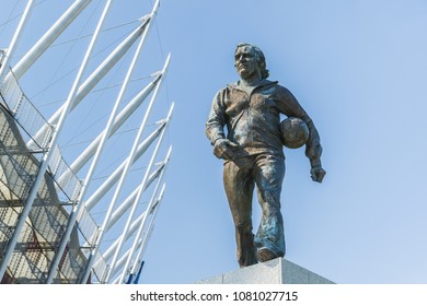 Statue Of The Polish Coach Kazimierz Gorski With A Ball Walking In His Tracksuit Outside The National Stadium On The Blue Sky Commemorating Seventies Of The Football Glory. Warsaw Poland 2018/4/30