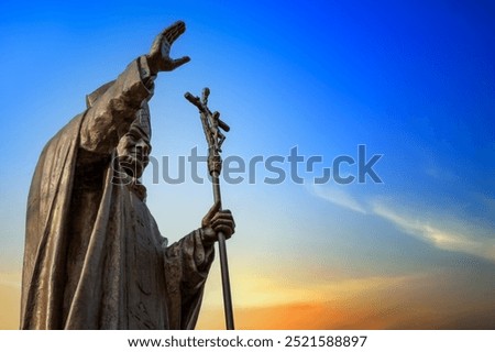 Statue of Pope John Paul II at sunset