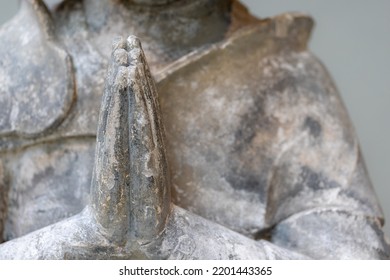 Statue praying. Selective focus image of hands in prayer.  Close-up of hands together on a memorial sculpture. Faith and religion concept.