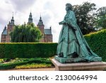 Statue of Queen Caroline Amalie of Augustenburg with the Frederiksborg Castle in the background. Royal statue.
