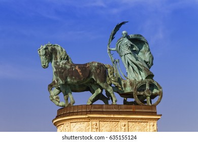 Statue Representing Peace, A Woman Holding A Palm Frond On A Chariot, On A Colonnade In Heroes Square Or Hosok Tere, Budapest, Hungary.