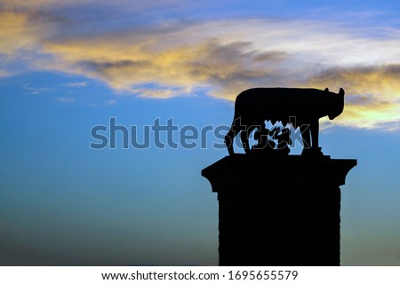 statue of Romulus and Remus on a backlit pedestal with a very beautiful sky in the background