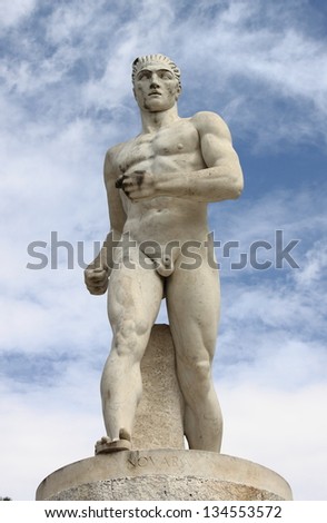 Statue of a runner in the Marble Stadium of Rome, Italy