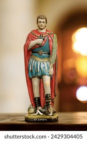 Statue of Saint Expedite in  blurred religious church background