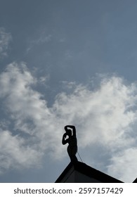 Statue shadow with blue sky background