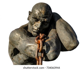 Statue Of A Slave Carrying A Boat Using A Chain, Isolated On White Background. Public Statue In A Park Of The City Of Santana De Parnaiba, In Sao Paulo, Brazil