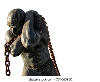 Statue Of A Slave Carrying A Boat Using A Chain, Isolated On White Background. Public Statue In A Park Of The City Of Santana De Parnaiba, In Sao Paulo, Brazil