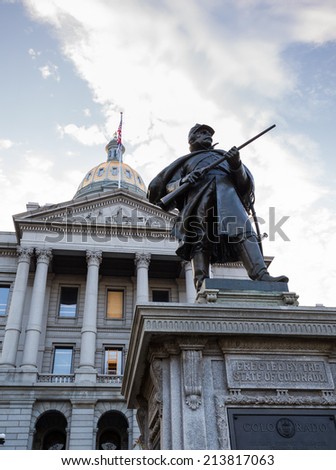 Statue of solider in front of the State Capitol Dome in Denver Colorado shortly after sunrise
