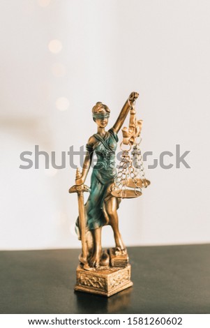 Statue of Themis on a white background, justice