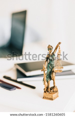 Statue of Themis on a white background, justice