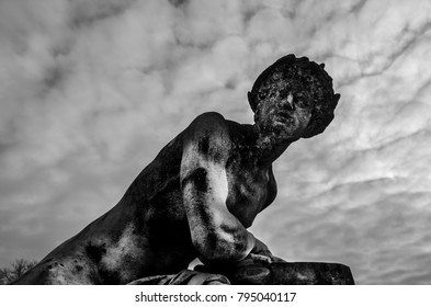 Statue under the clouds