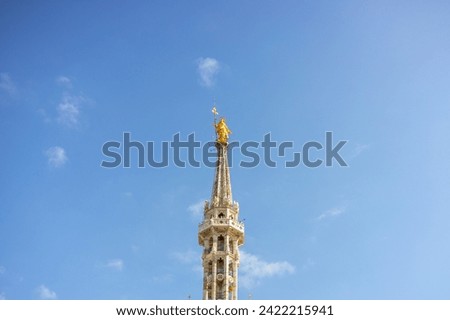 Statue of the Virgin Mary on top of Duomo Cathedral, Milan Cathedral. Madonna Golden Statue Perfect Bronze Replica in Milan, Italy