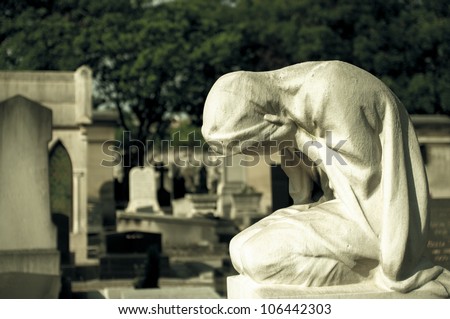 Statue of weeping woman on a grave