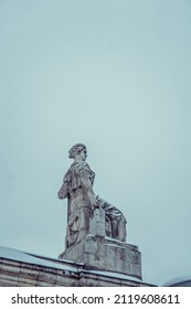 
Statue Of A Woman Sitting On A Chair, Photo During The Day