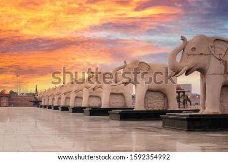Statues of elephants placed in a straight line in the famous landmark Ambedkar Park of Lucknow. The red sandstone work and beautiful reflective floor add to the beauty