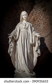 Statues of Holy Women in Roman Catholic Church on wall background.