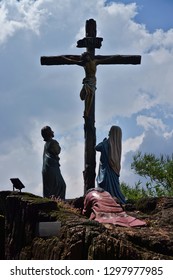 Statues Of Jesus Crucified With People Underneath Him