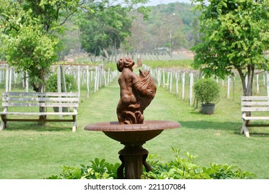 Statues Of Nude Children In Garden Background