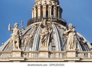 Statues of saints John the Baptist, Jesus Christ and St Andrew and cupola of St. Peter's basilica, Vatican, Rome, Italy, Europe