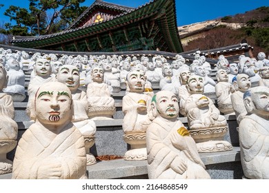 Statues of some of he 500 Buddha’s Disciples white statues by a temple hall in Bomunsa Temple on the island of Seongmodo, Ganghwa, Incheon, South Korea.