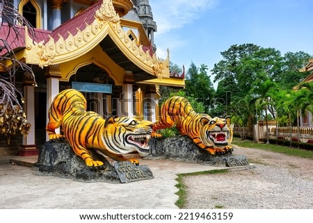 Statues of tigers at entrance to buddhist pagoda Tham Sua near Tiger Cave Temple in Krabi, Thailand. Two tiger sculptures at the entrance to the Thai traditional temple in Krabi.