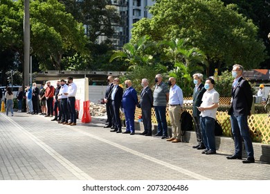 StatueSquare,Central,HongKong-11Nov2021:Remembrance day,Armistice Day,people with mask on face and red poppy flower on body,feeling sad,standing in front of cenotaph,to mourn soldiers died in worldwar