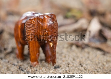 Statuette of wooden elephant  on blur background. Quality photo for art work and advertised. image of hand made.