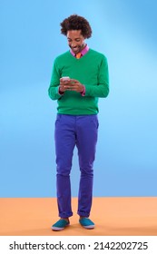 Status Update Looking Sweet. Studio Shot Of Stylish Young Man Talking On The Phone Against A Colorful Background.